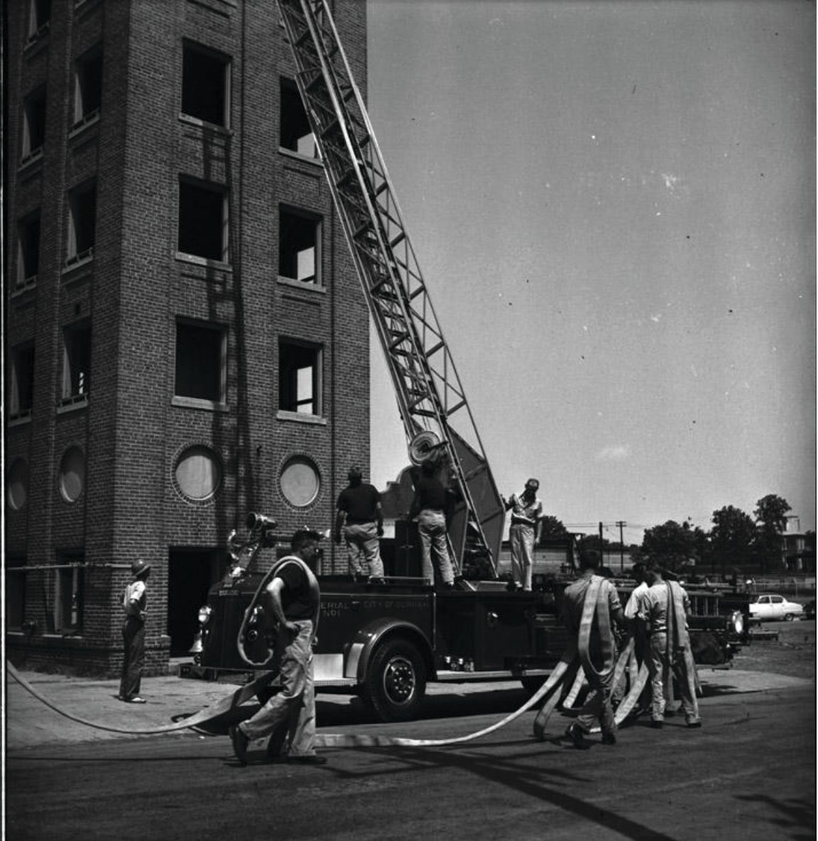 Historic firetruck with ladder going to the top of the fire tower